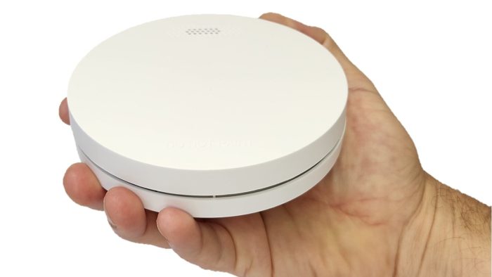 ZEN Photoelectric Smoke Alarm held in the hand showing slimline design